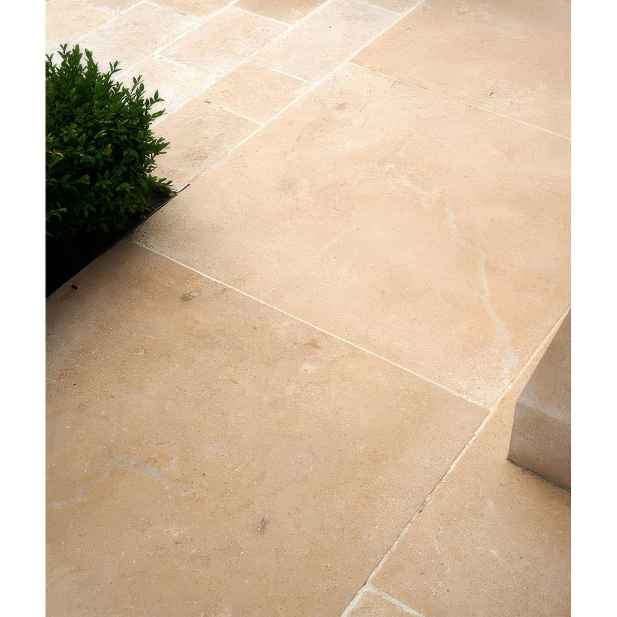 Beige buscot limestone paving tiles with tumbled and etched finish featuring natural textured surface and tone variations