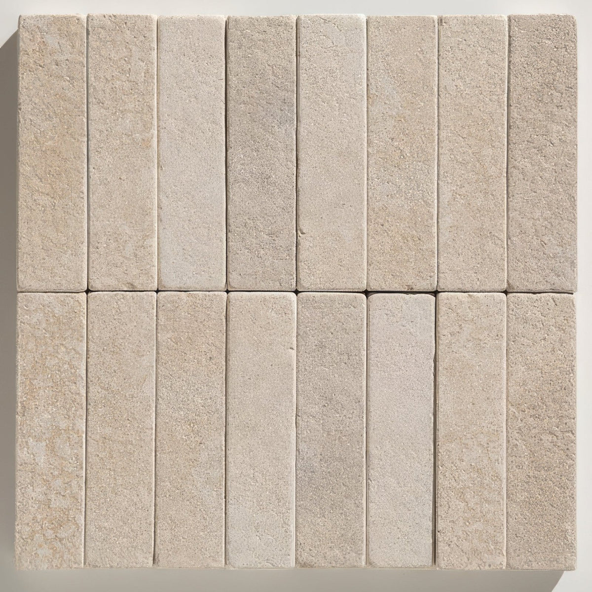 Beige rectangular buscot limestone tumbled and etched klinkers with textured natural stone surface