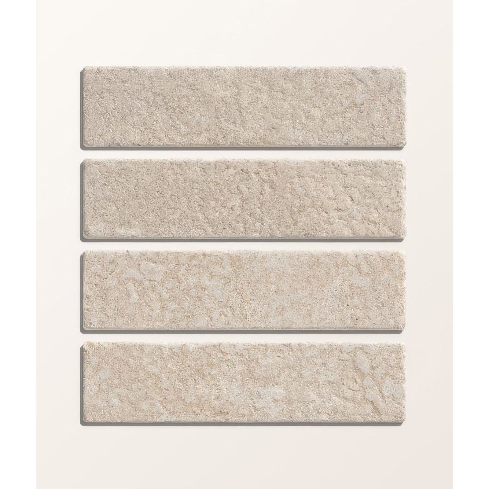 Four beige buscot limestone tumbled and etched klinkers tiles with textured natural surface shown from front side
