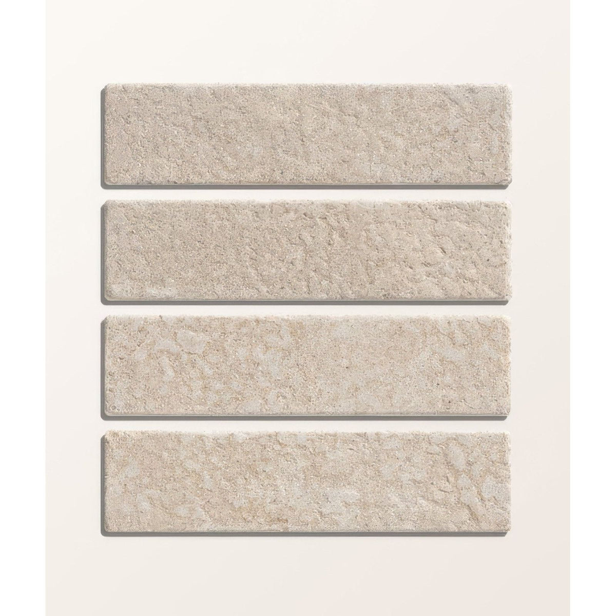 Four beige buscot limestone tumbled and etched klinkers tiles with textured natural surface shown from front side