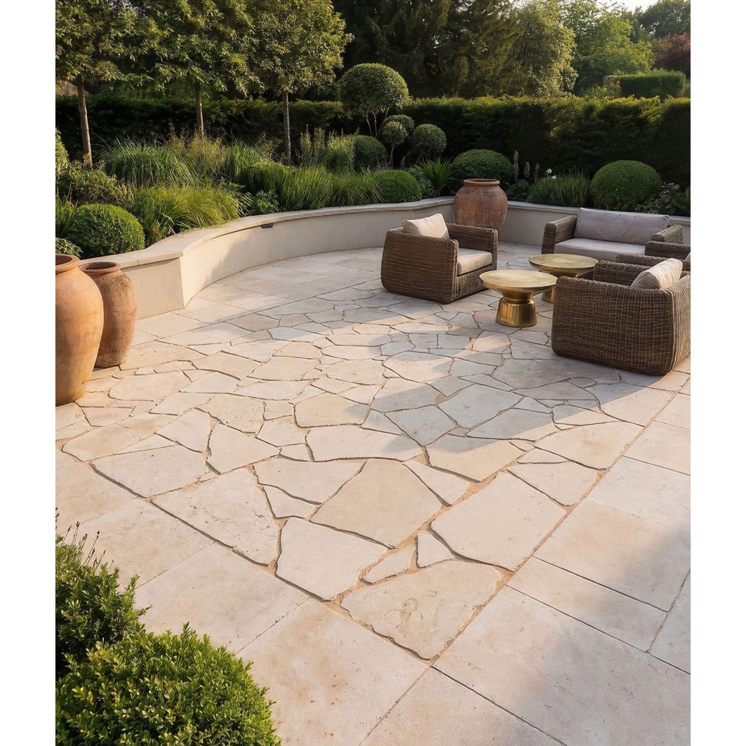 Outdoor patio with stone flooring, wicker furniture, and greenery.