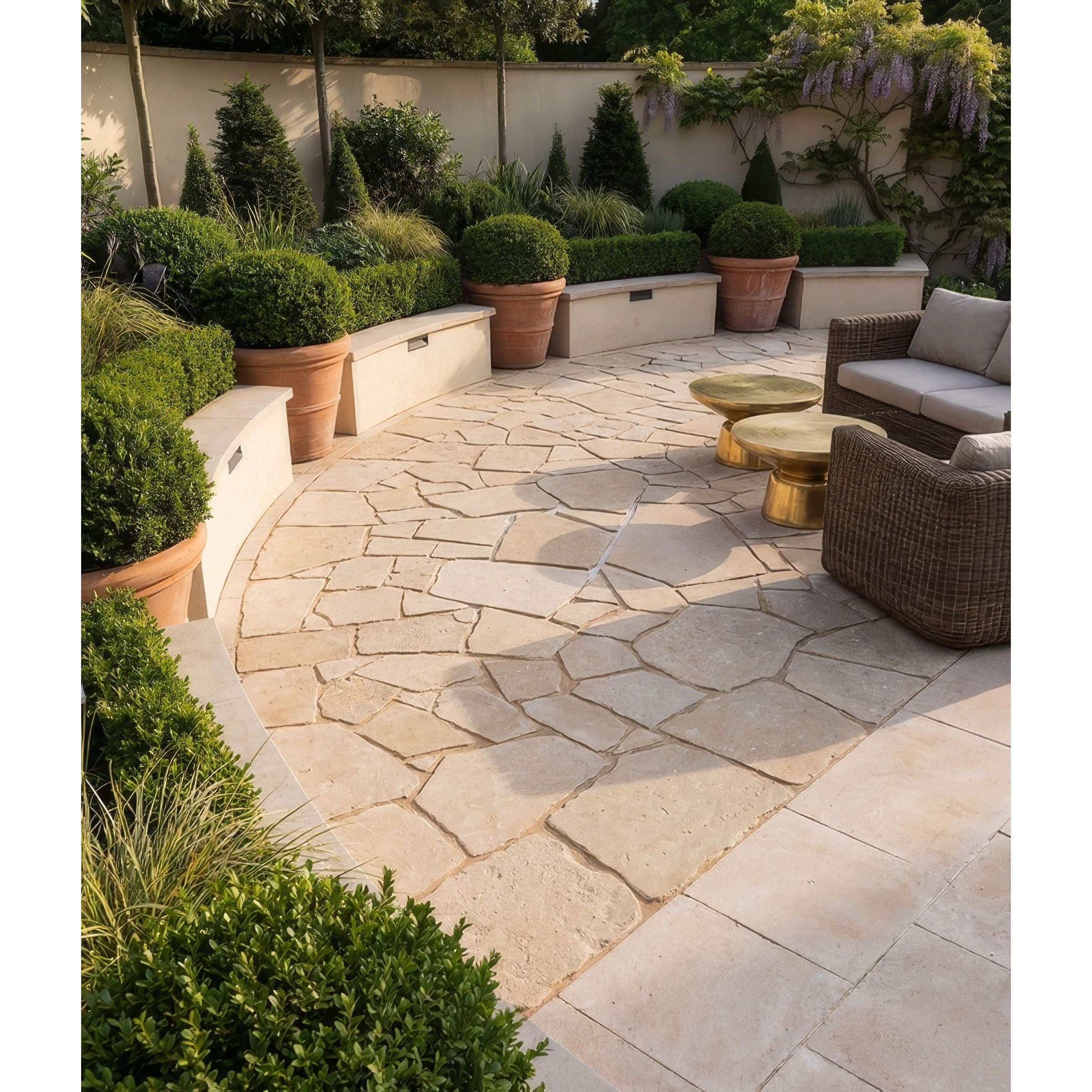 Outdoor patio with stone flooring, potted plants, and wicker furniture.