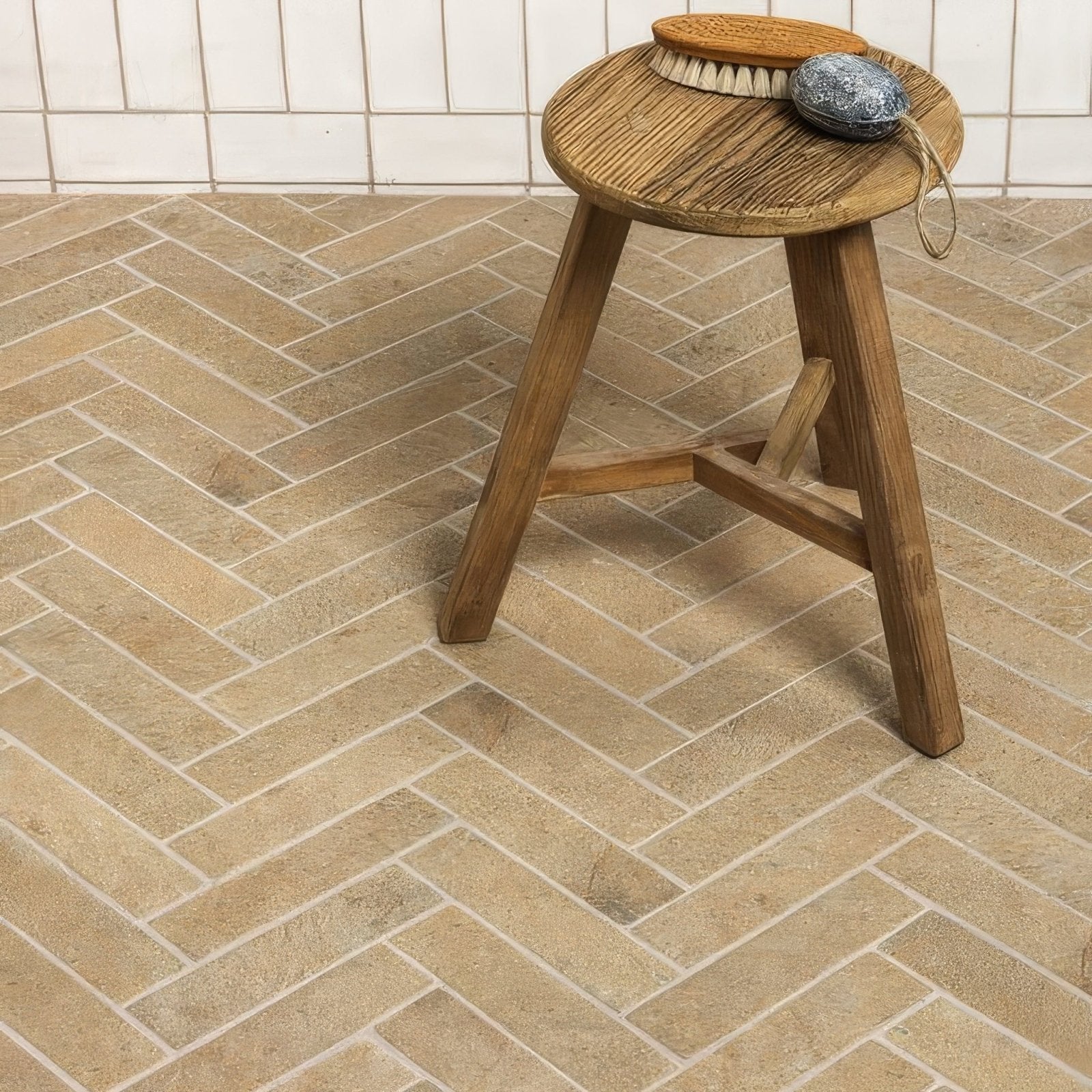 Rustic wooden stool with a round porcelain parquet textured seat and sturdy tripod legs for versatile seating