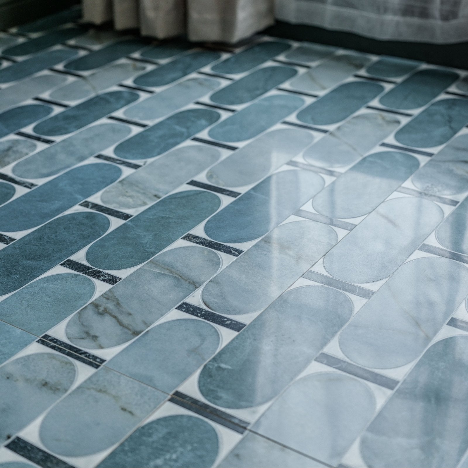 Byzantine porcelain lauro sculpted blue and white marble patterned oval floor tiles arranged in geometric design