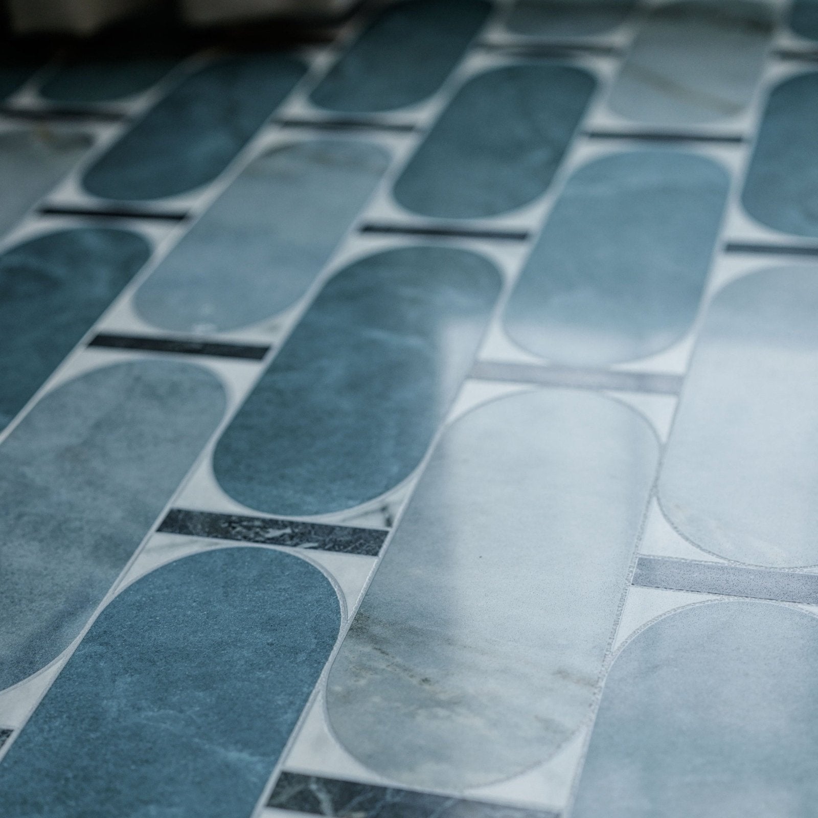 Blue and white marble mosaic tile floor featuring elongated oval shapes from byzantine porcelain lauro sculpted collection