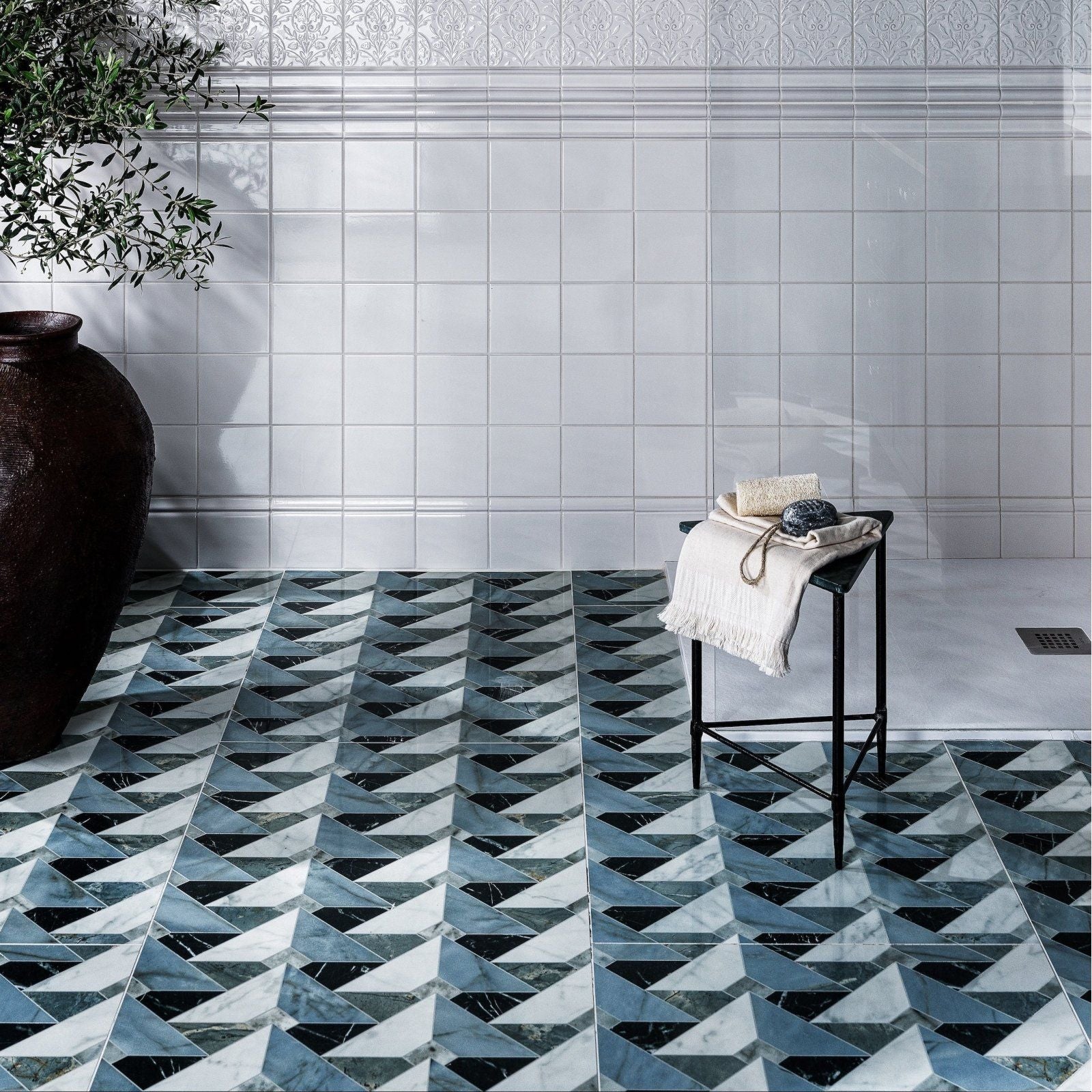 Geometric mosaic floor tiles in black white and blue marble patterns from the byzantine porcelain seraph sculpted collection