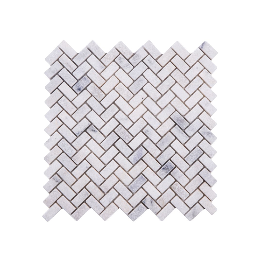 Sheet of Carrara White tumbled marble herringbone mosaic with softened edges and fine grey veining