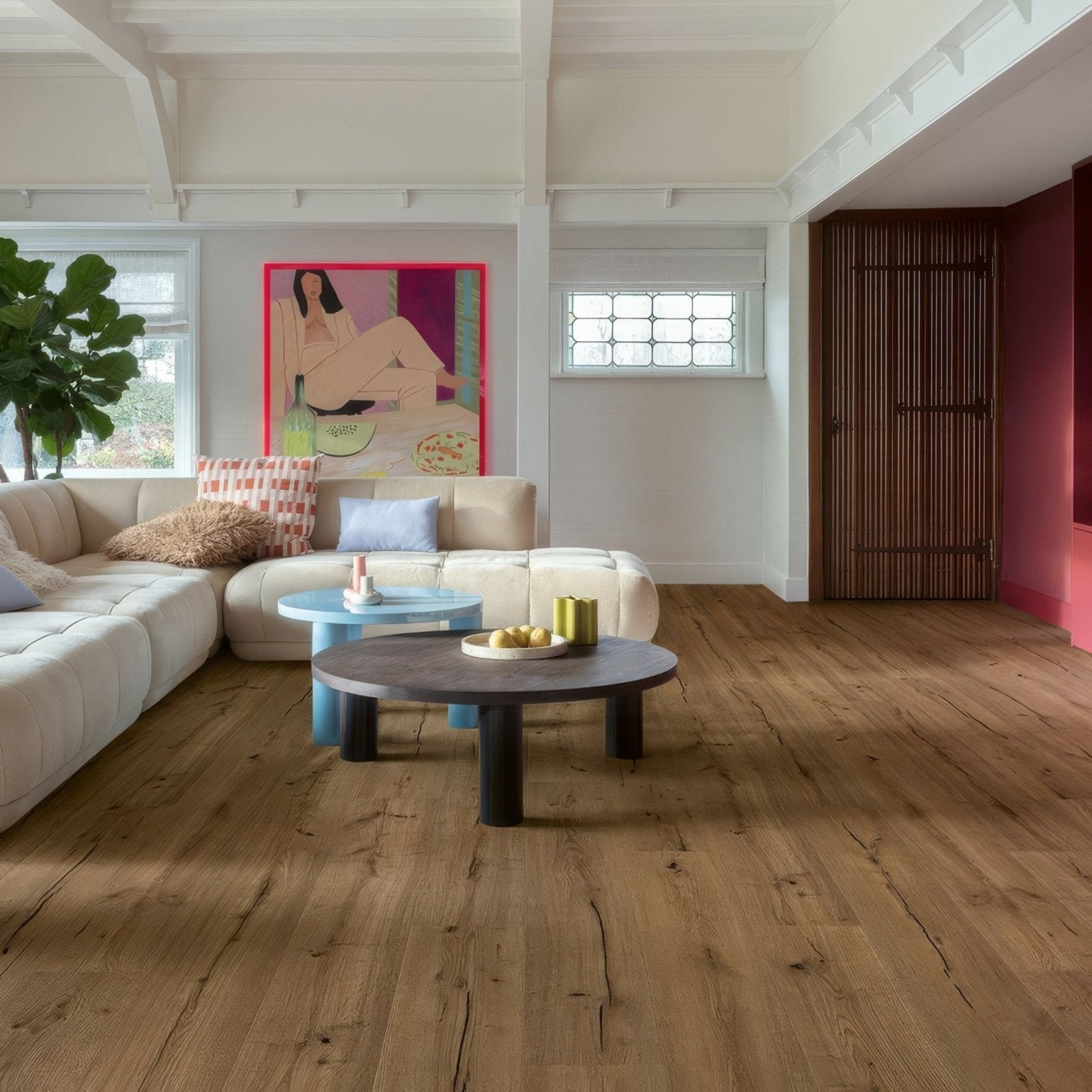 A round dark wood coffee table with black legs and minimalist design on café rené f038 long vinyl planks flooring