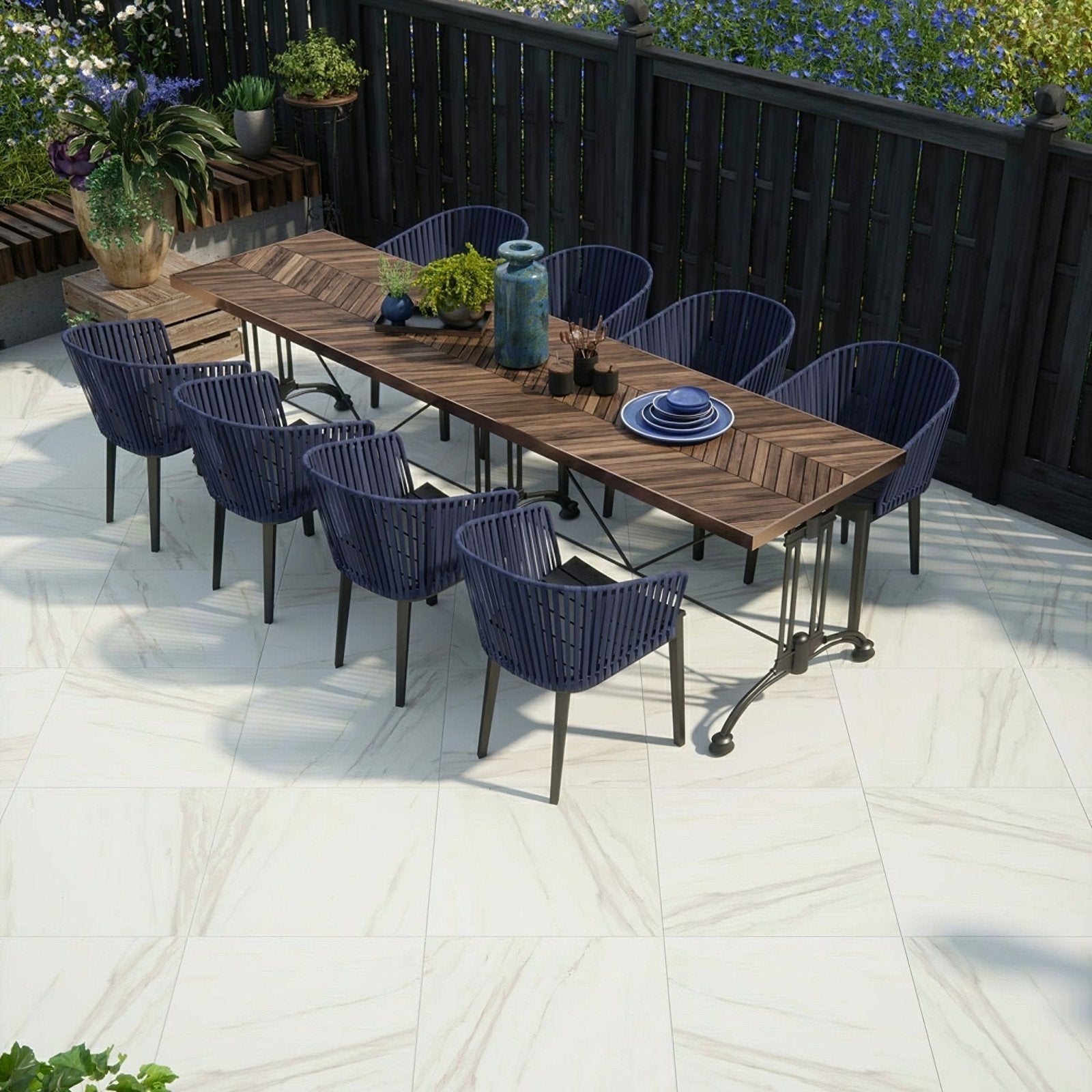 Dark blue woven resin outdoor dining set with wooden table metal legs on calacatta gold matt porcelain paving