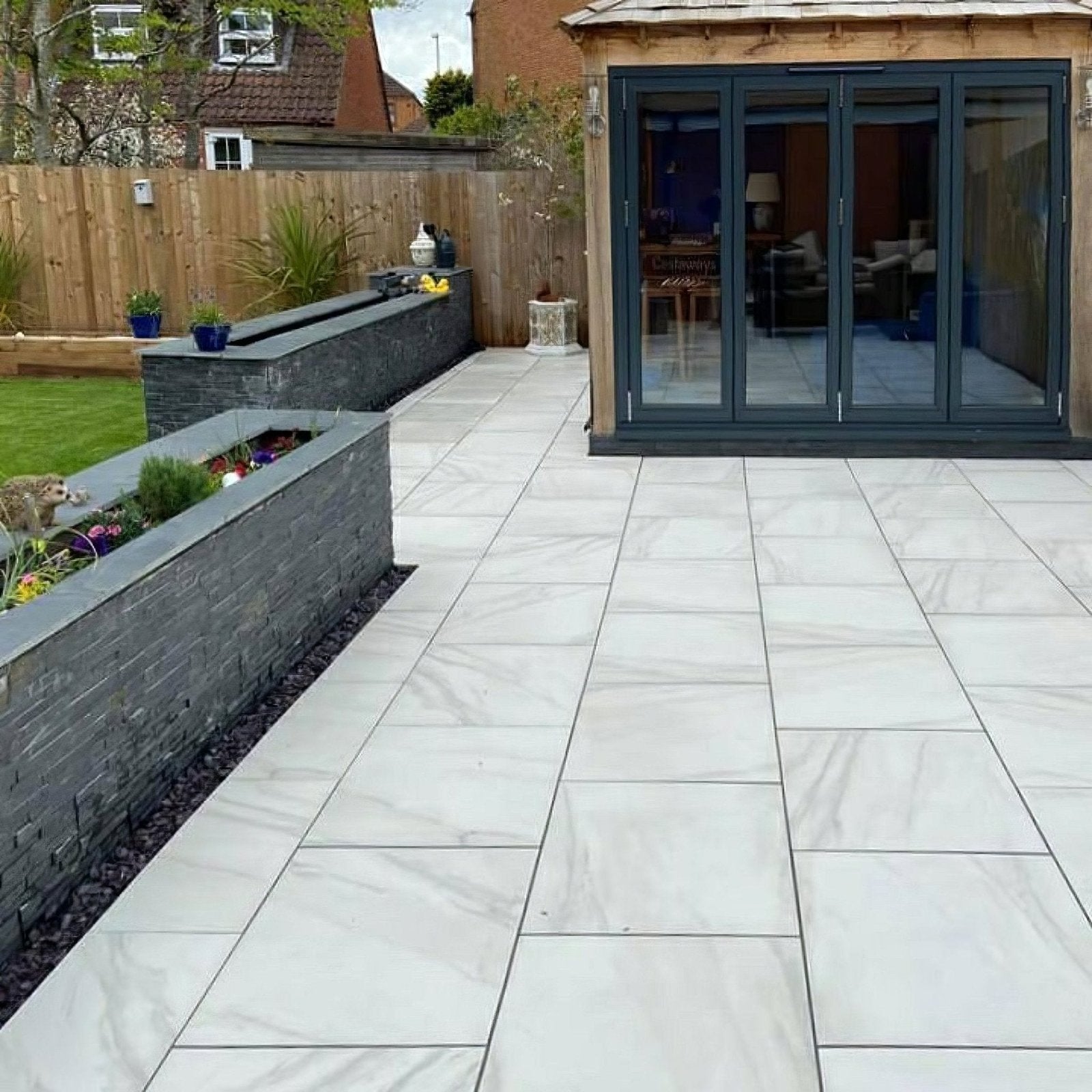 Calacatta gold matt porcelain paving with white marble effect tiles featuring subtle gray veining for patios