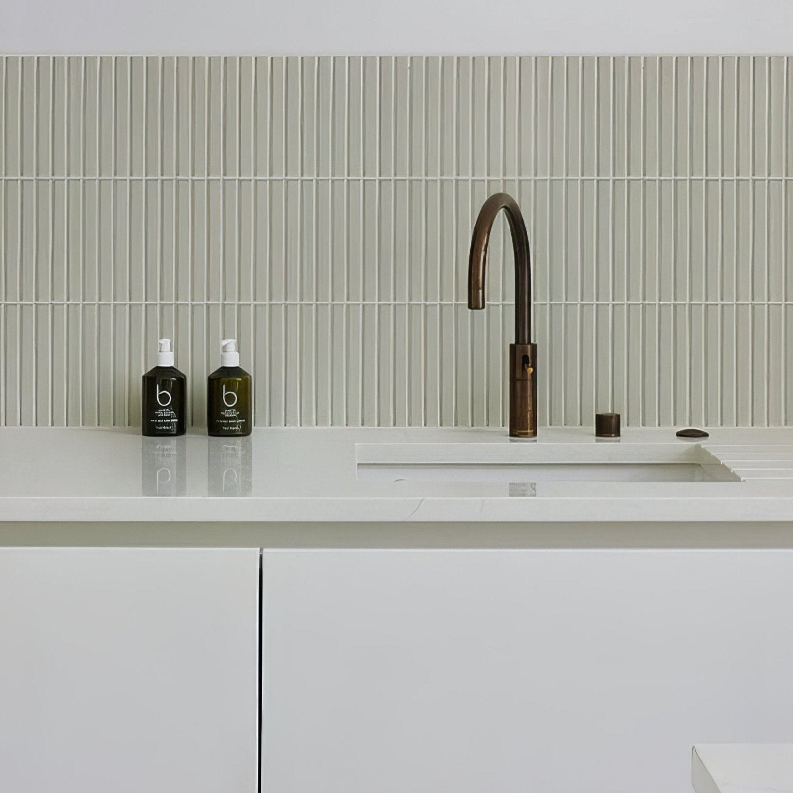 Bronze-finished kitchen faucet with curved spout and modern design featured in candy cane porcelain mosaic vanilla product