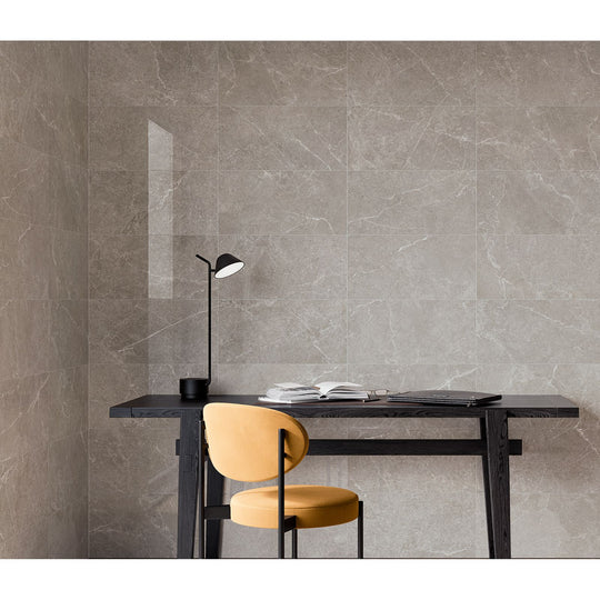Capitol Grey Polished grey stone-effect tiles with a black desk lamp