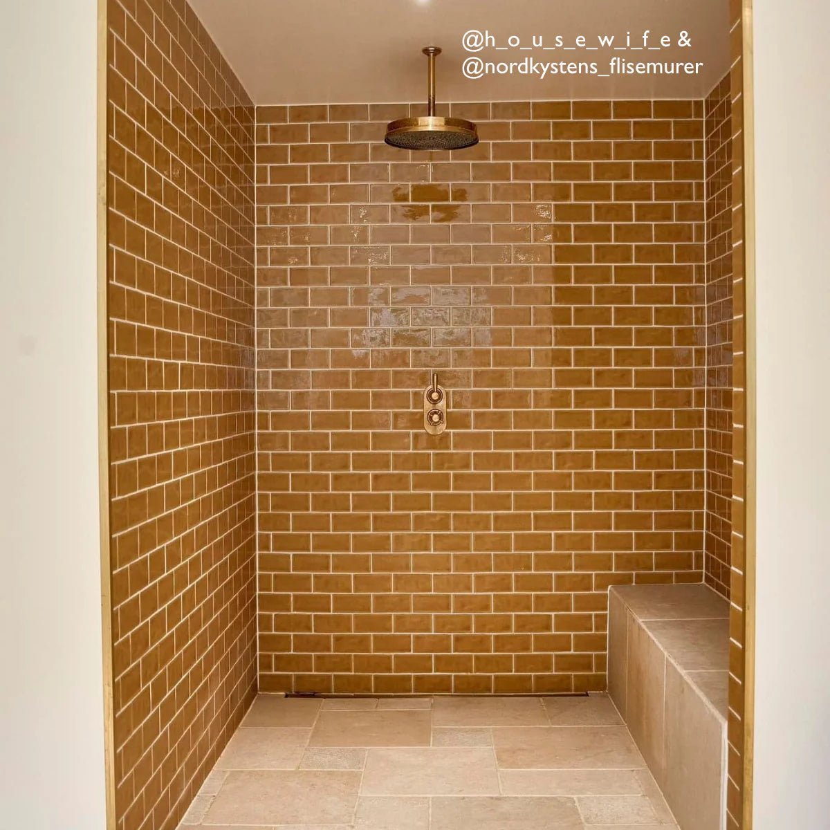 Brass showerhead with circular textured surface and polished finish in carnival oro yellow glazed tile design