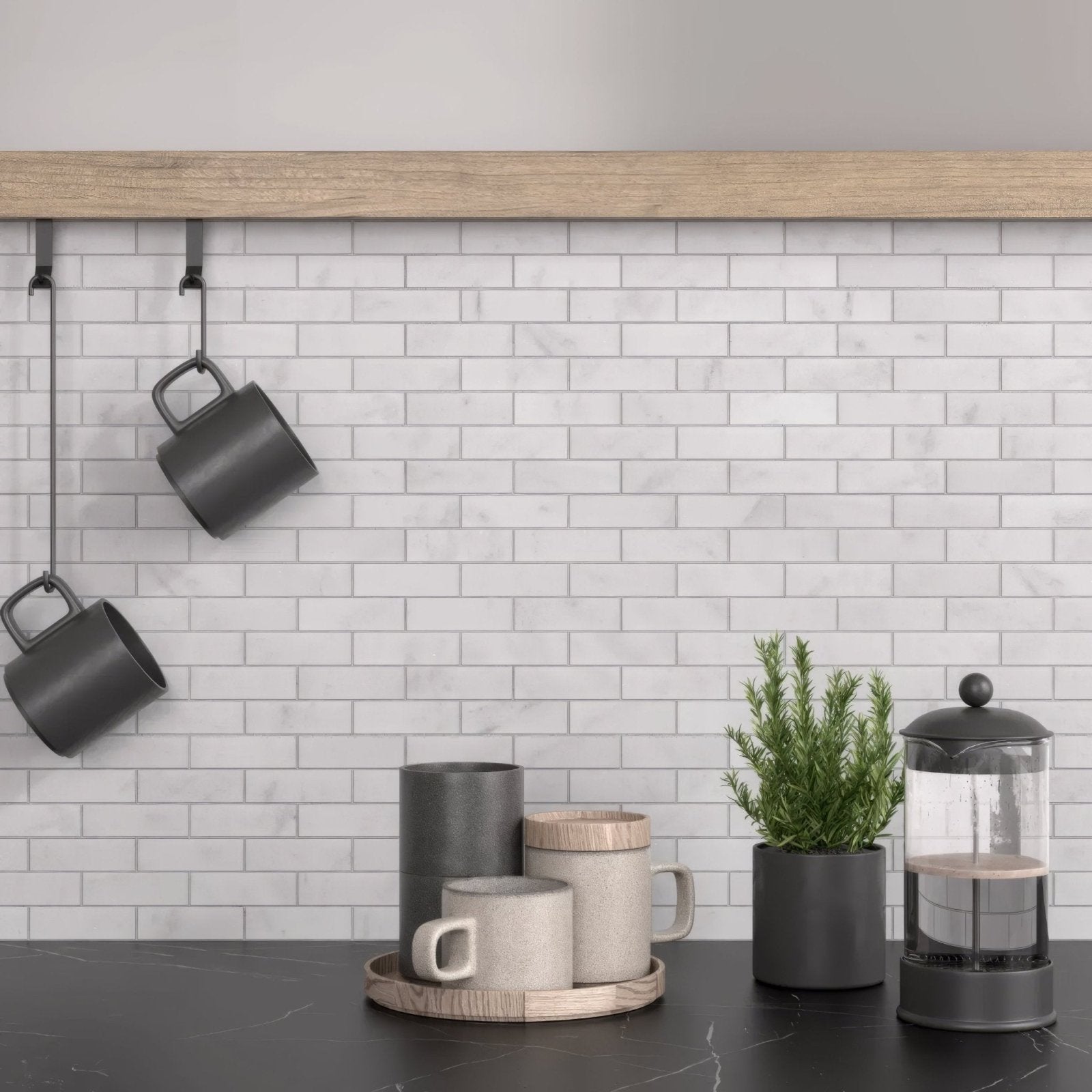 Gray ceramic mugs with matte finish and minimalist design arranged on a wooden tray with carrara white marble brick mosaic tile background