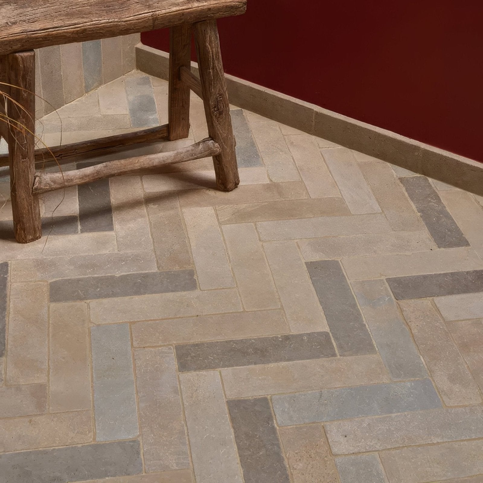 Beige and gray herringbone patterned castilan limestone parquet tumbled stone floor tiles in natural tones