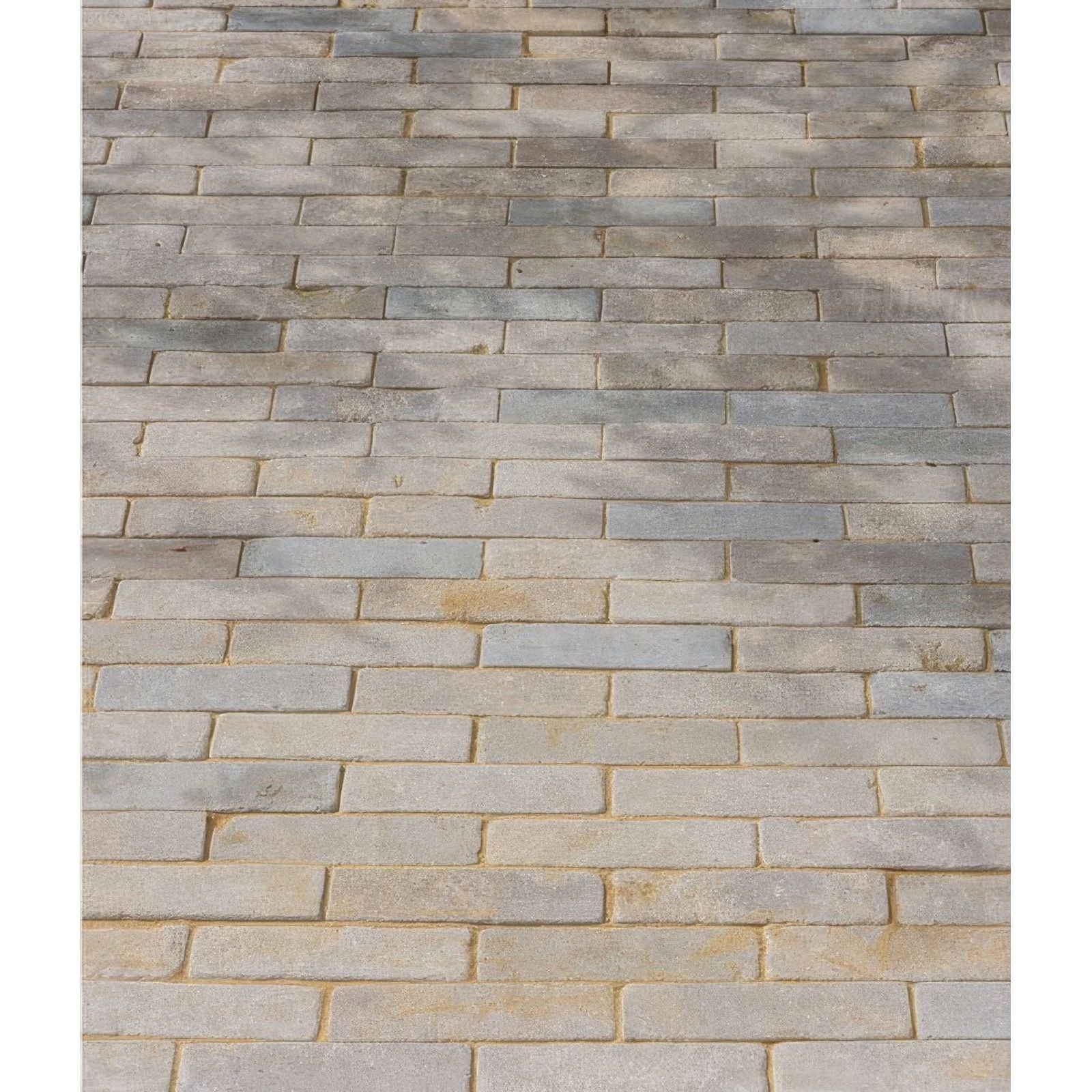 Castilan limestone tumbled klinkers in gray and beige rectangular paving stones arranged in a staggered brick pattern