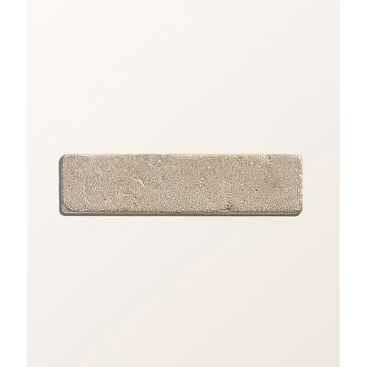 A rectangular silver-toned castilan limestone tumbled klinker with a matte finish and subtle surface texture