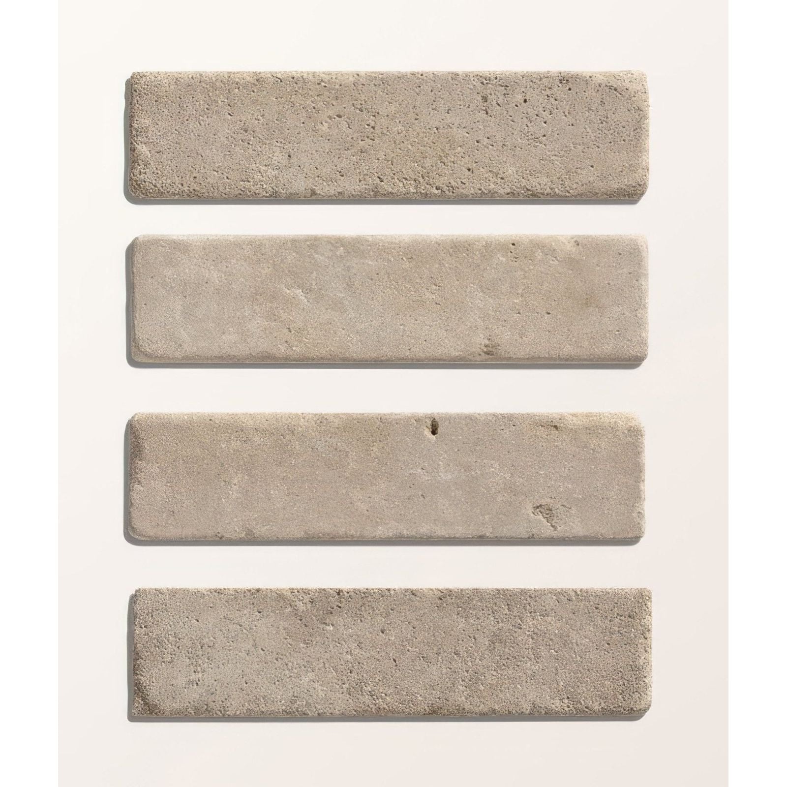 Four light gray castilan limestone tumbled klinkers with a textured rustic surface rectangular stone tiles