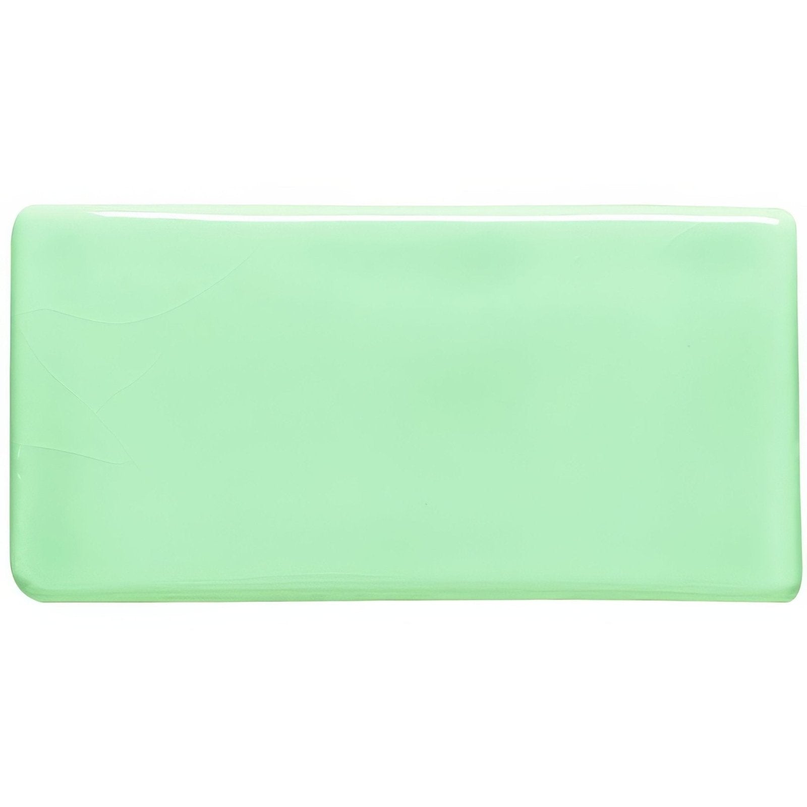 A smooth rectangular mint green celadon ceramic half tile with rounded edges and a glossy finish
