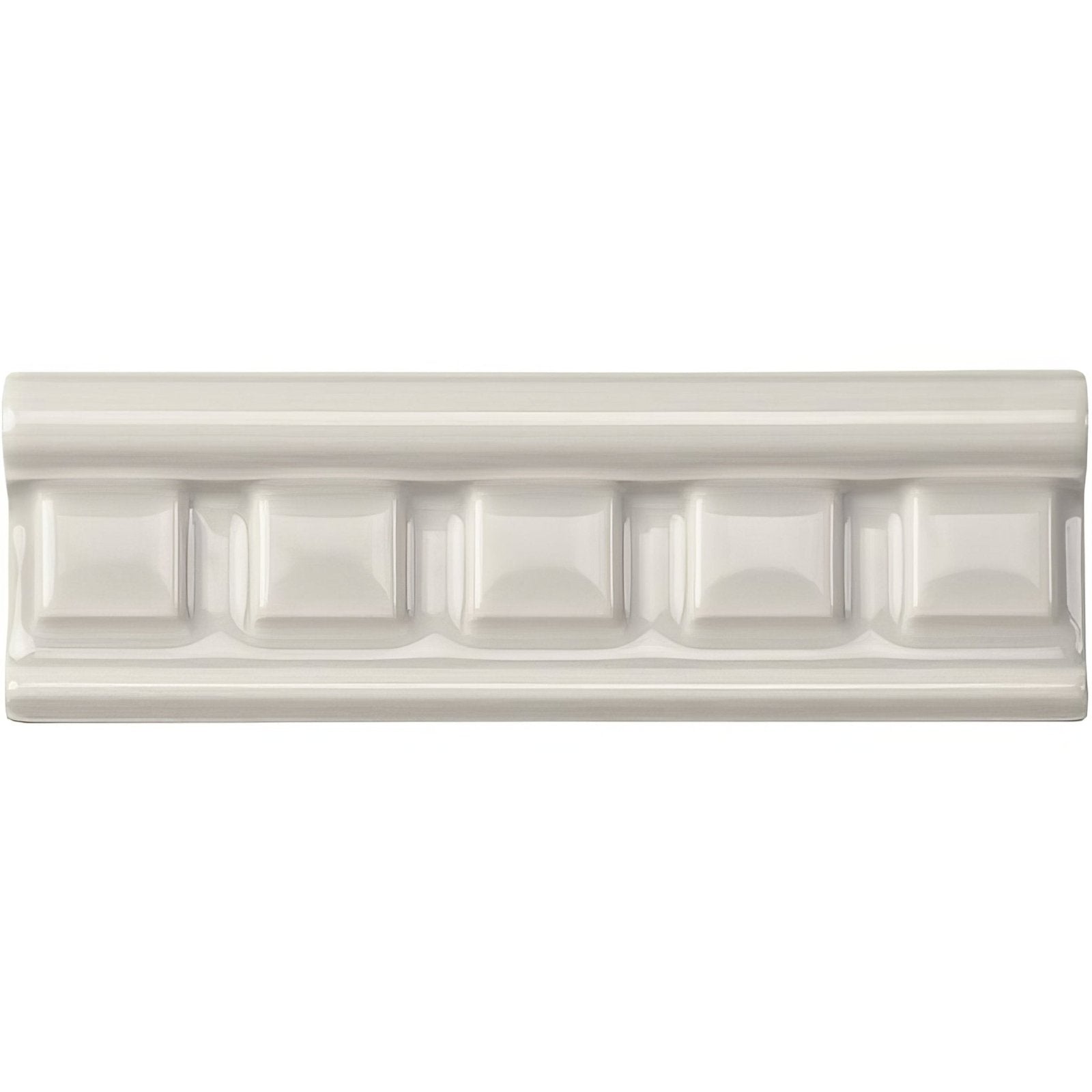 Cream-colored ceramic baseboard tile with classic raised rectangular molding design chancel grey dentil moulding