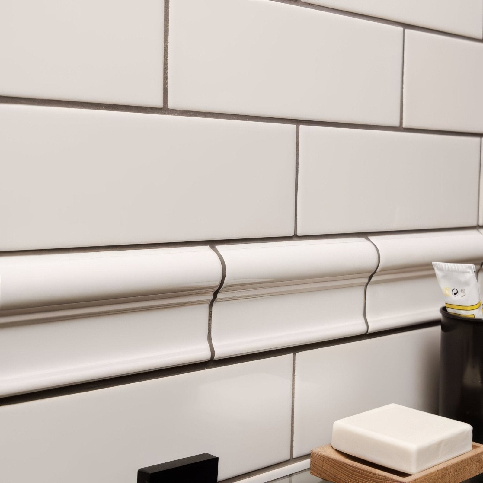White ceramic subway tile with subtle glossy finish and dark grout lines in chancel grey large brick pattern