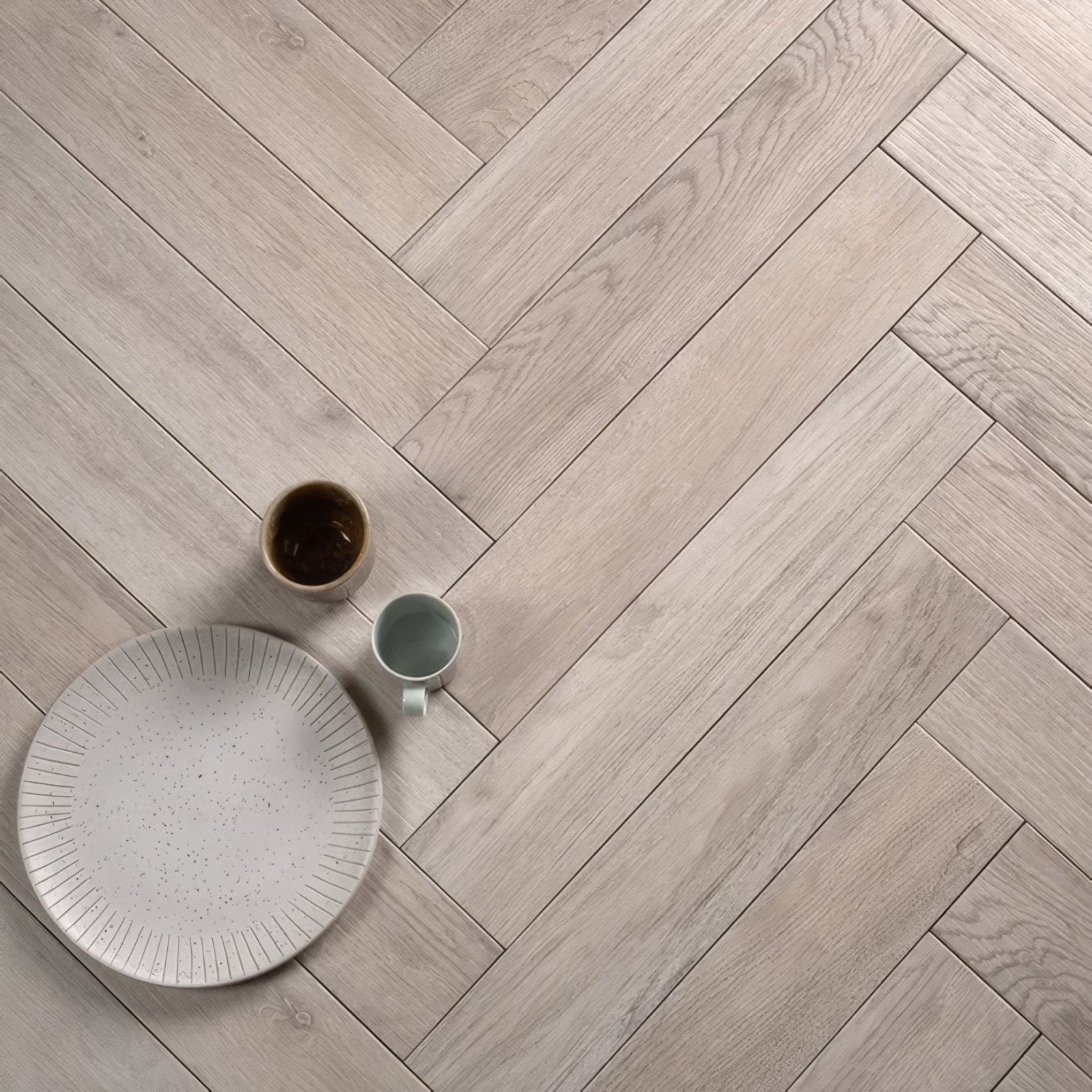 Light gray porcelain floor tiles in a wood-effect herringbone pattern from chatham porcelain natural collection