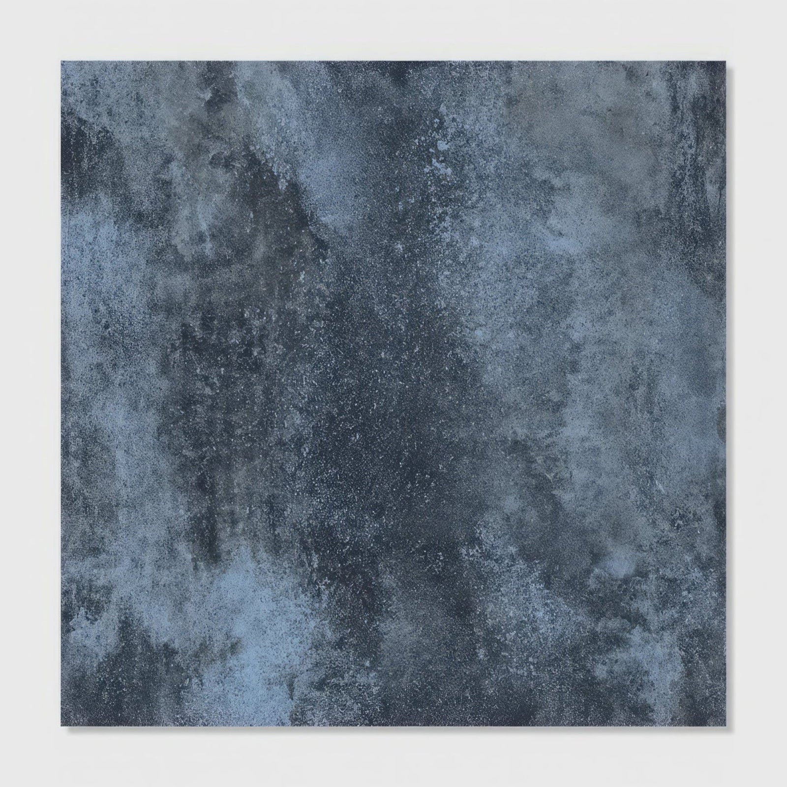 Dark blue chemistry porcelain denim tile with textured mottled weathered finish for interior surfaces