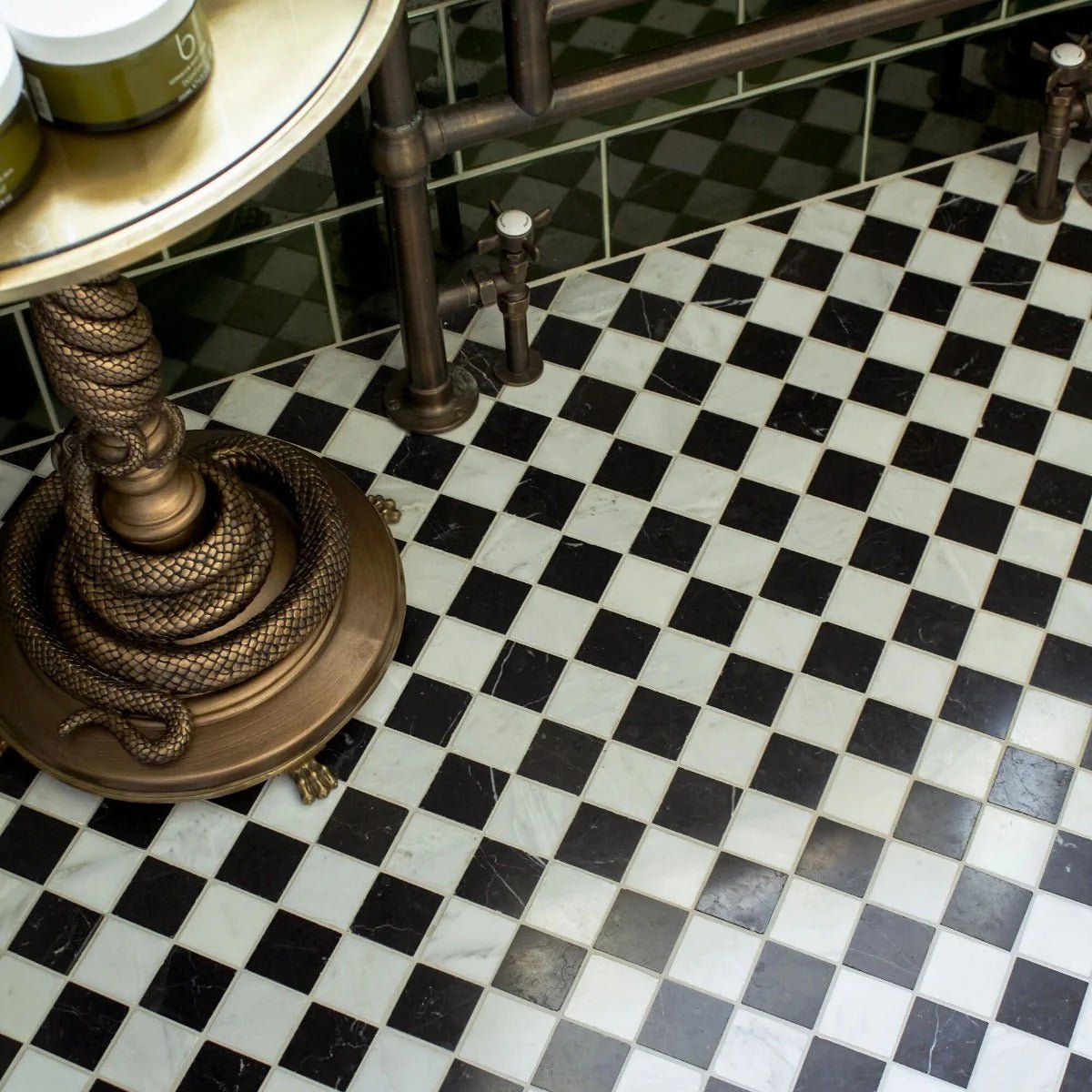Chequers Court 4.8sq White & Black bevelled edge black and white checkered tiles with a bronze snake ornament on a pedestal