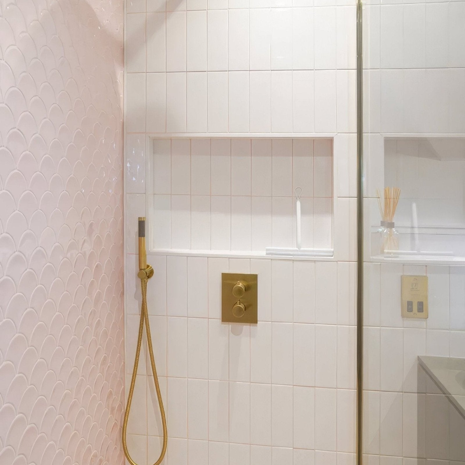 Gold-toned chic ceramic white showerhead with sleek modern design and flexible hose for enhanced bathroom style