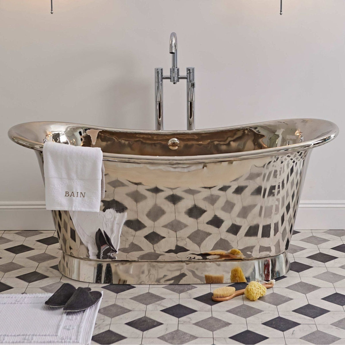 Chiesa Black black and white marble mosaic flooring with a chrome freestanding bathtub