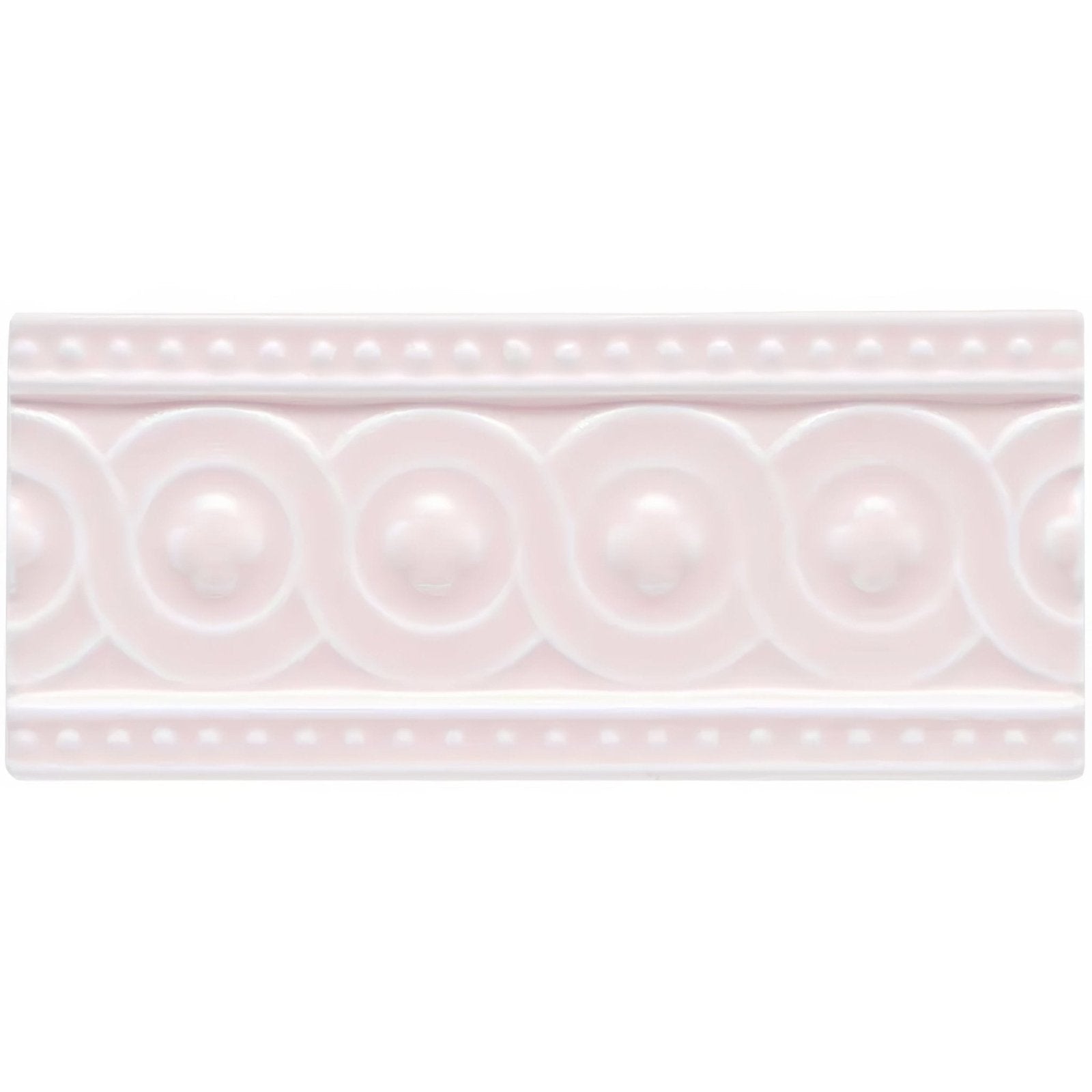 A delicate pink ceramic tile clare baroque with raised circular medallions and dotted border pattern