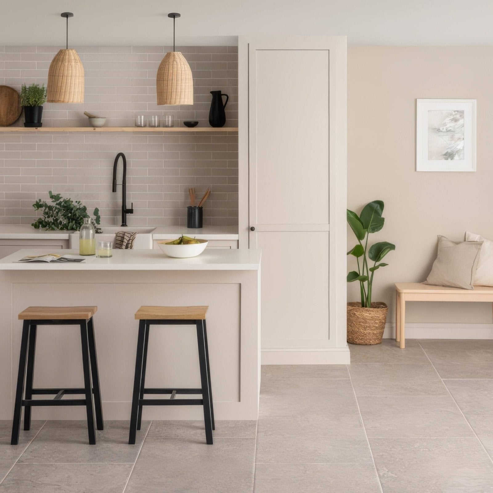 Minimalist white kitchen island with smooth countertop and integrated sink featuring cliff brick tile and black wooden stools