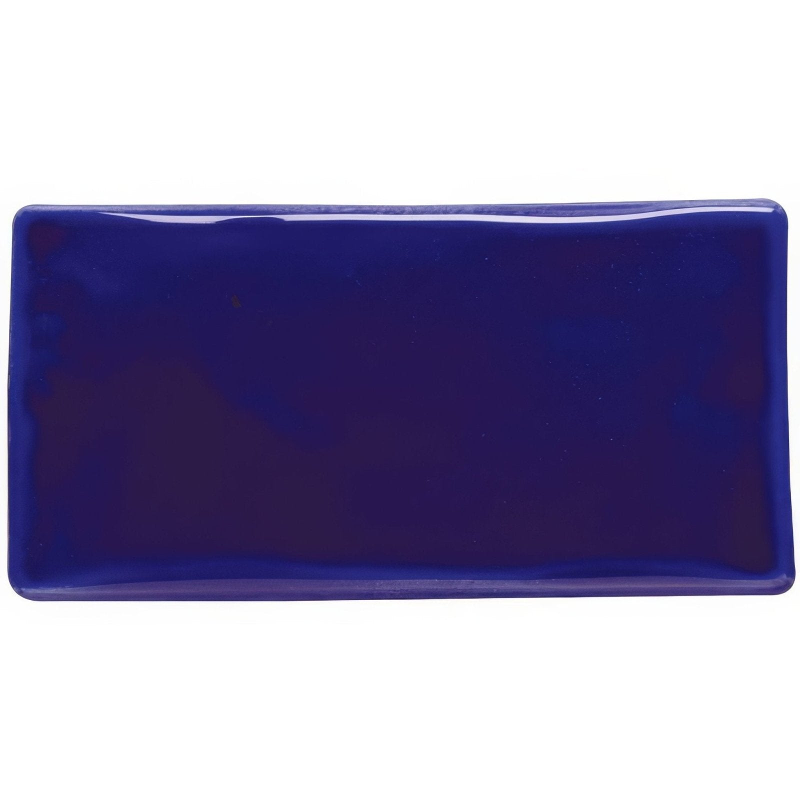 A glossy royal blue rectangular ceramic tile with rounded edges called cobalt blue half tile