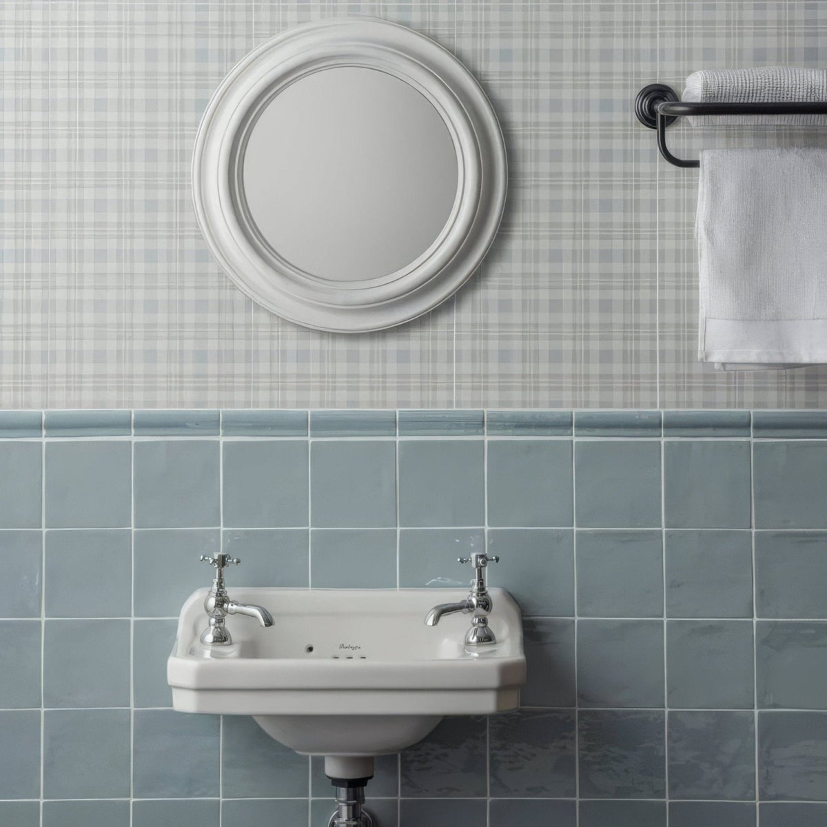 White ceramic wall-mounted sink with chrome cross-handle faucets set against cornflower field tile background