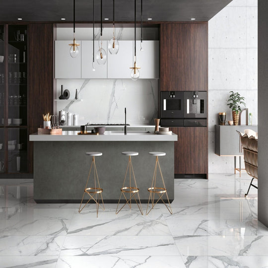 Cosmopolitan Statuario Extra Lappato 80 x 80cm white marble-effect tiles with a kitchen island and gold bar stools