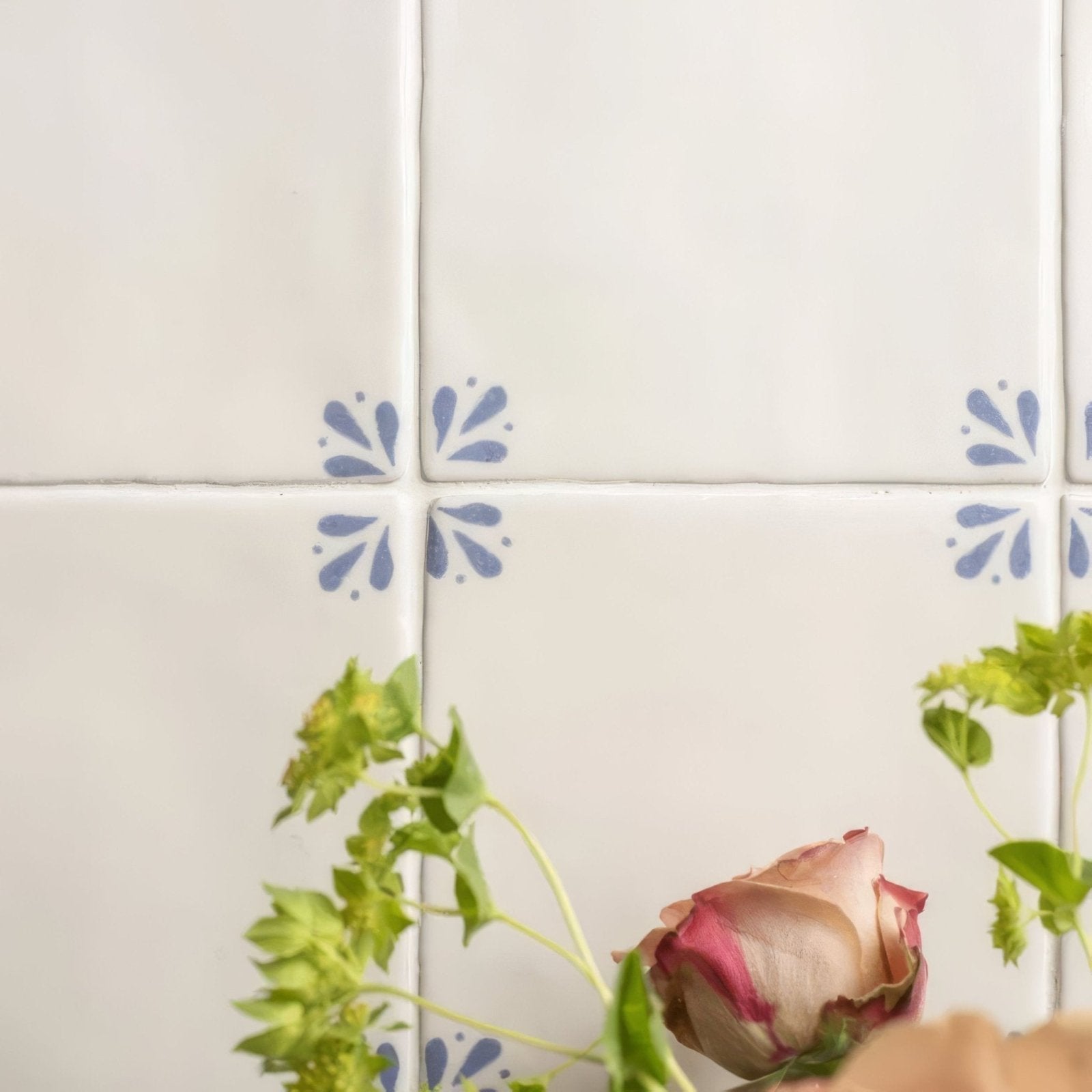 White ceramic tiles with delicate blue floral patterns from country delft cornelia collection