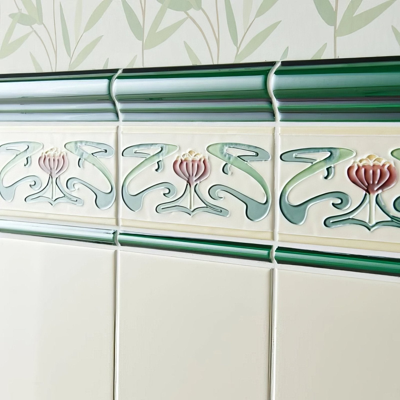 County white field tile featuring art deco ceramic border with raised pink and sage floral motifs on cream background