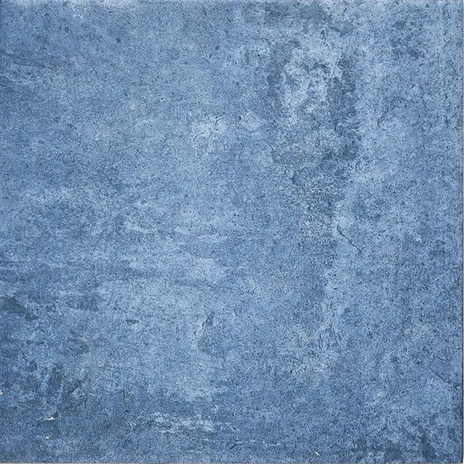 Blue textured stone tile with a mottled weathered surface from cuba porcelain indigo field collection