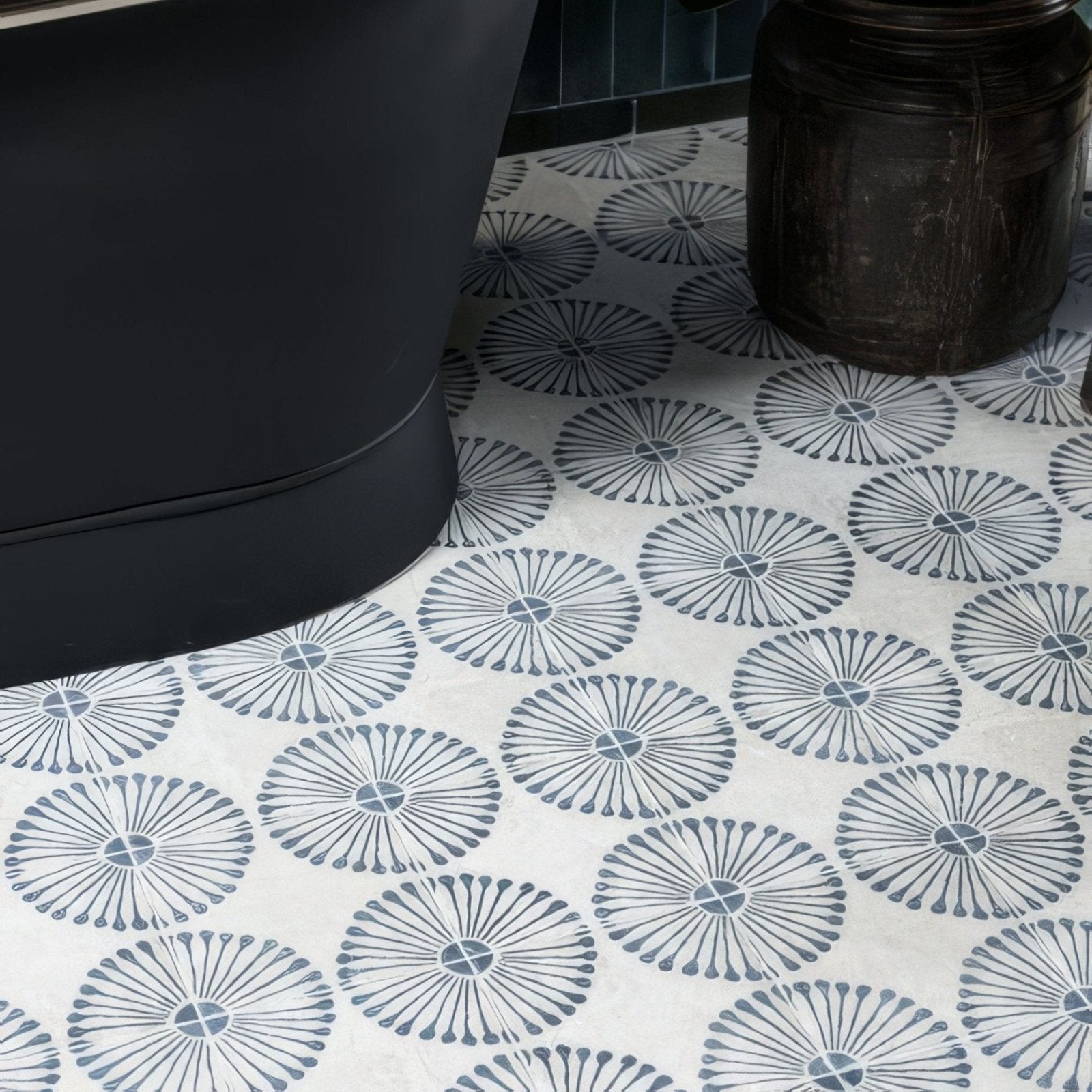 White ceramic floor tiles with dark gray sunburst motifs from cuba porcelain infantas blue collection