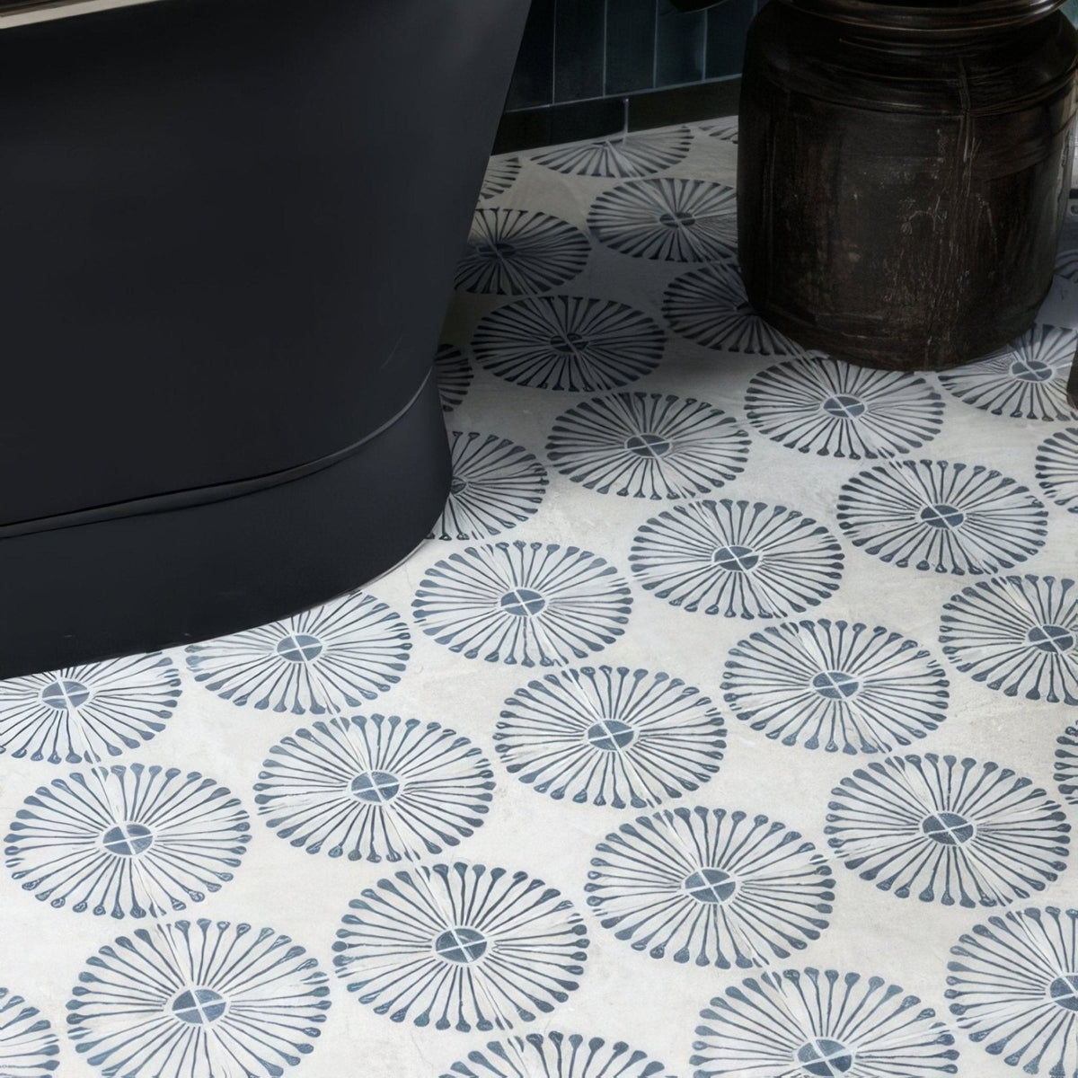 White ceramic floor tiles with dark gray sunburst motifs from cuba porcelain infantas blue collection