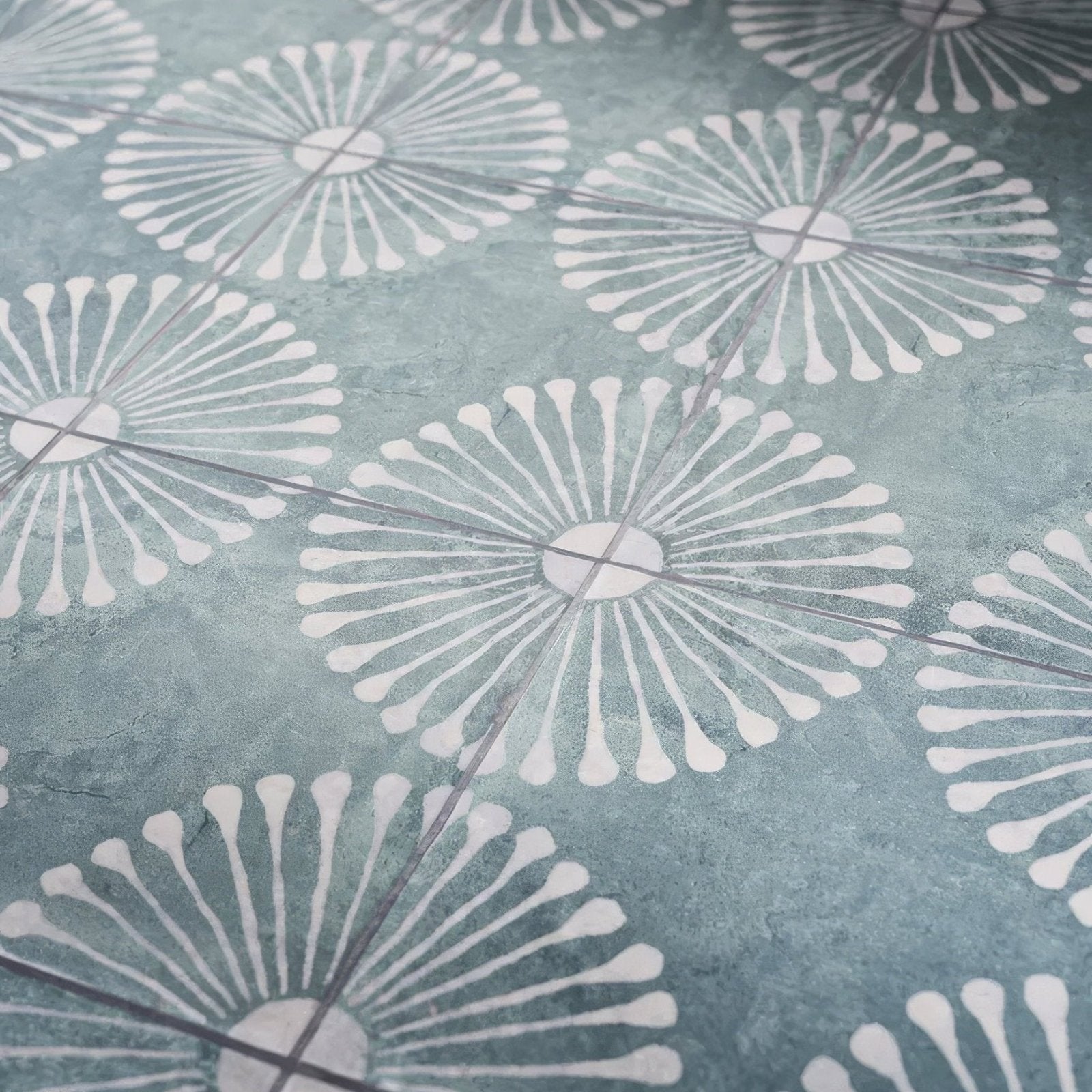 Teal-colored cuba porcelain vedado mint green floor tile with a repeating white dandelion floral pattern
