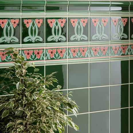 Dauphine border green ceramic tiles with pink and light green art nouveau floral patterns on victorian green background