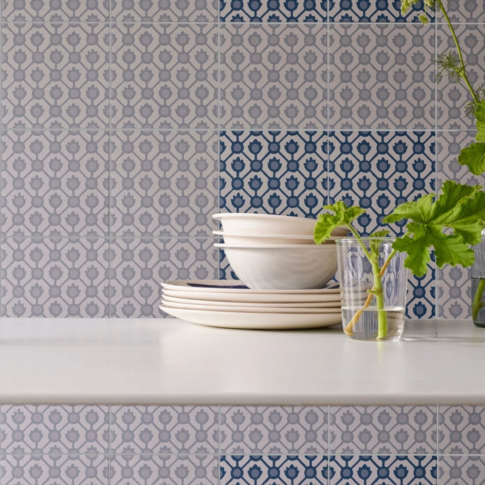 Stack of cream-colored cream-colored ceramic bowls with subtle matte finish on white countertop from designers guild jaal cobalt