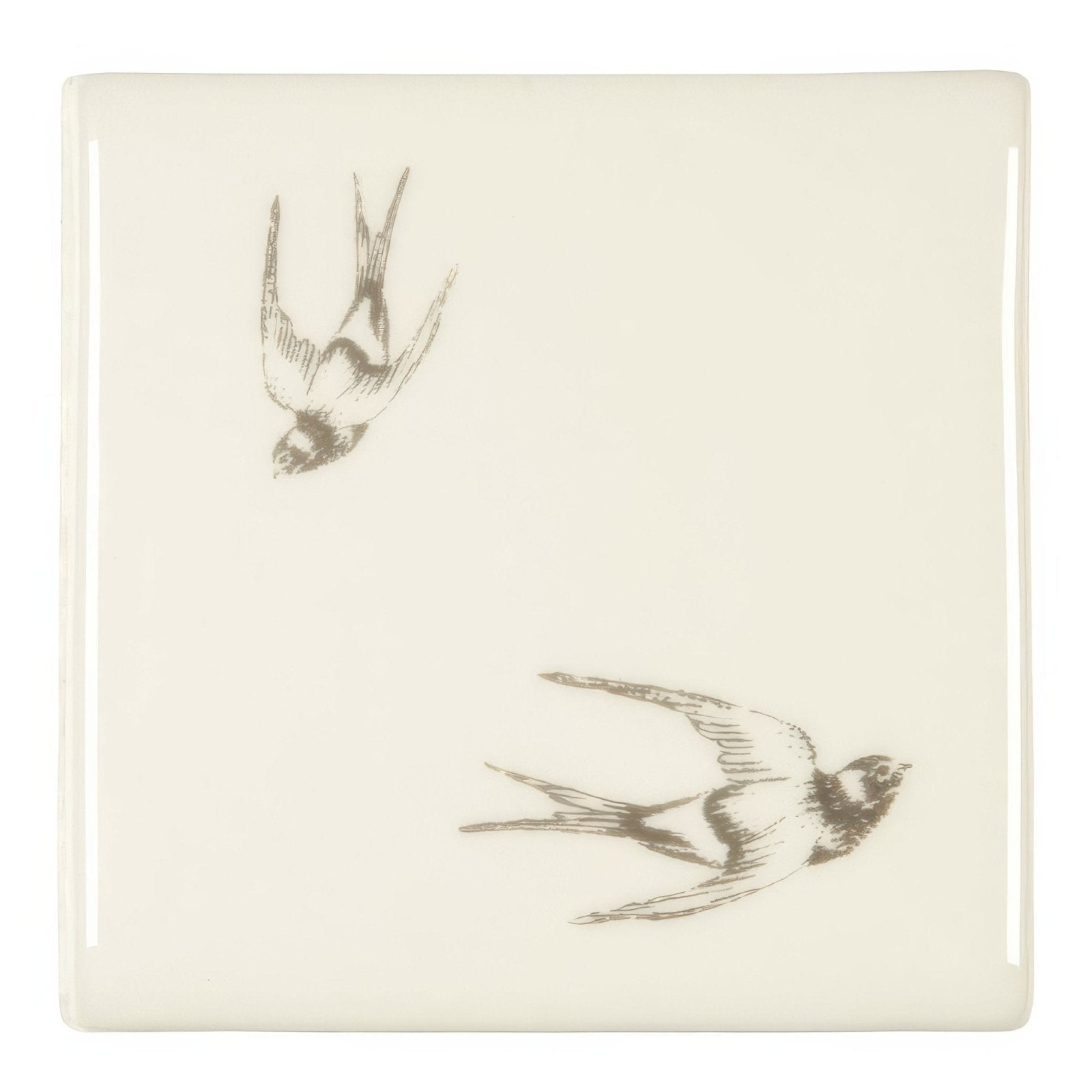 Cream-colored square coaster with two delicately illustrated swallow birds in dark gray ink sketch diving on off white