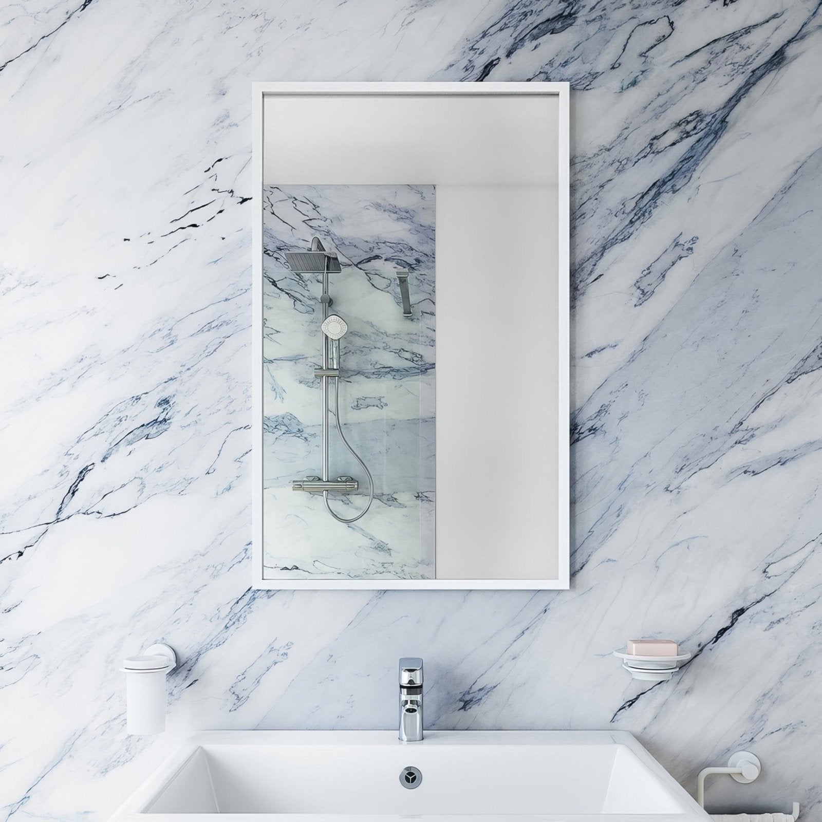 White framed rectangular bathroom mirror docklands 40x70cm mounted above a sink with clean modern design