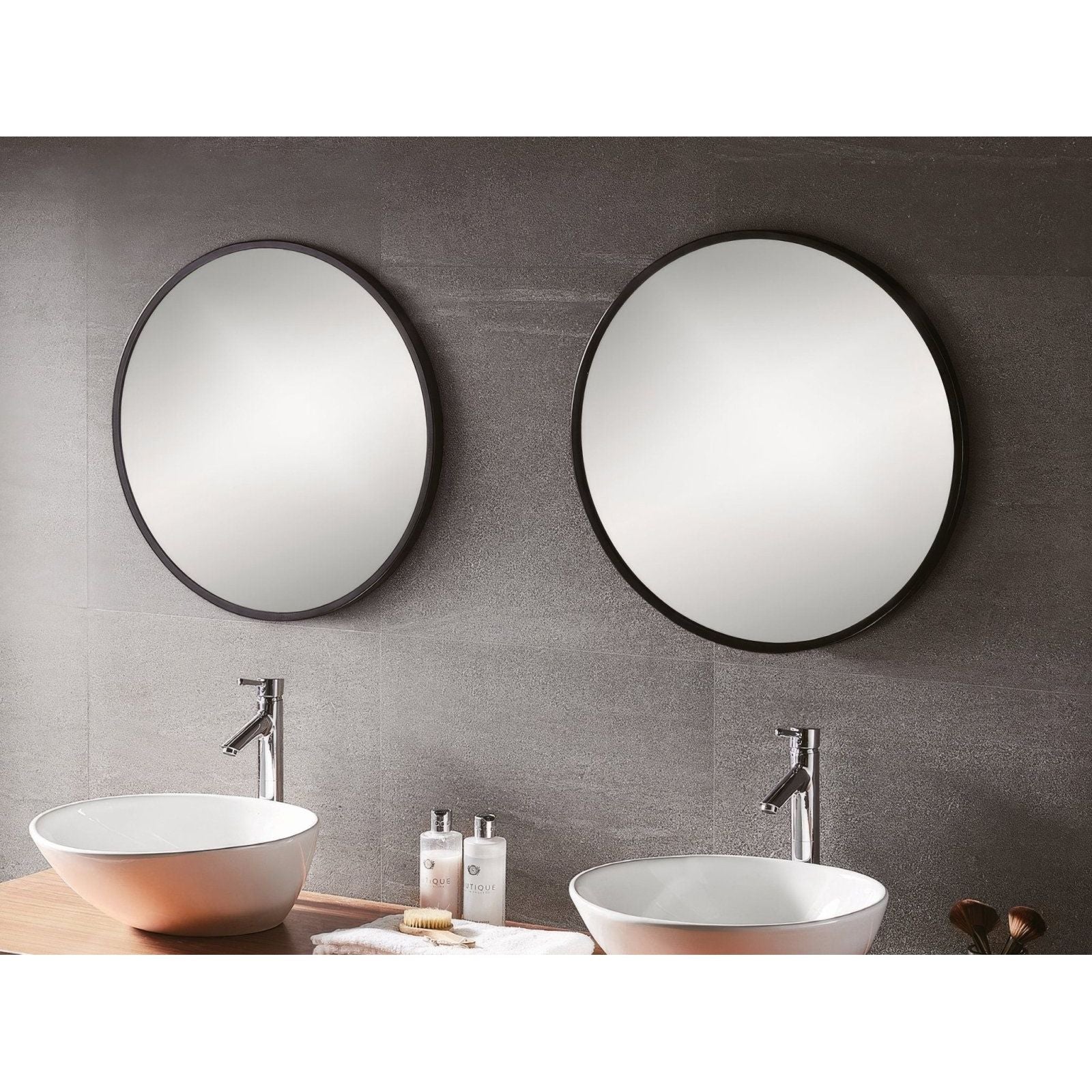 Two docklands round mirrors 80cm black framed mounted above white ceramic vessel sinks in a bathroom setting