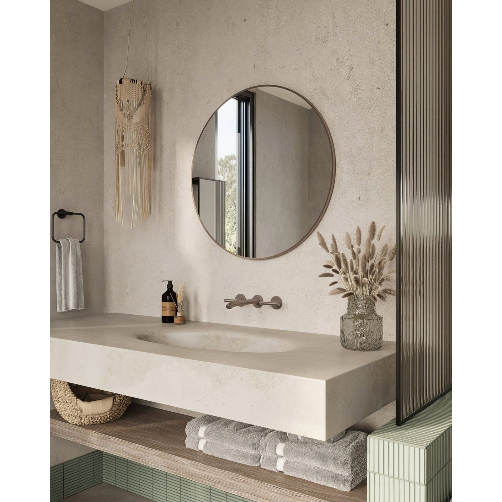 Round mirror with thin brushed bronze metallic frame mounted above sink in docklands round mirror 80cm design