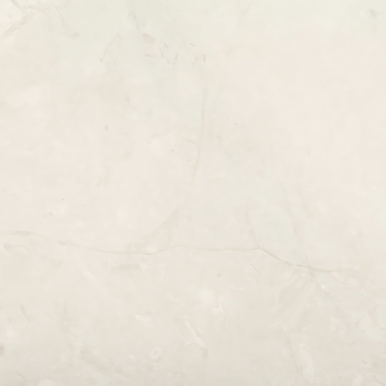 Dorzanotumbled edge and surface marble tile in cream color with subtle veining measuring 40.6 by 61 cm
