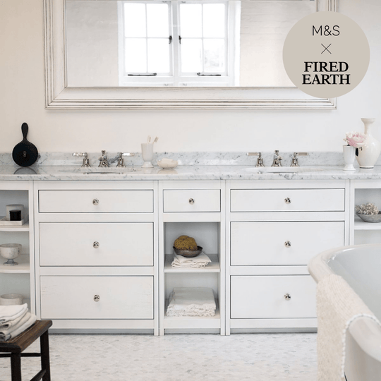 White marble dover cliffs double vanity with silver hardware and open shelving for bathroom storage