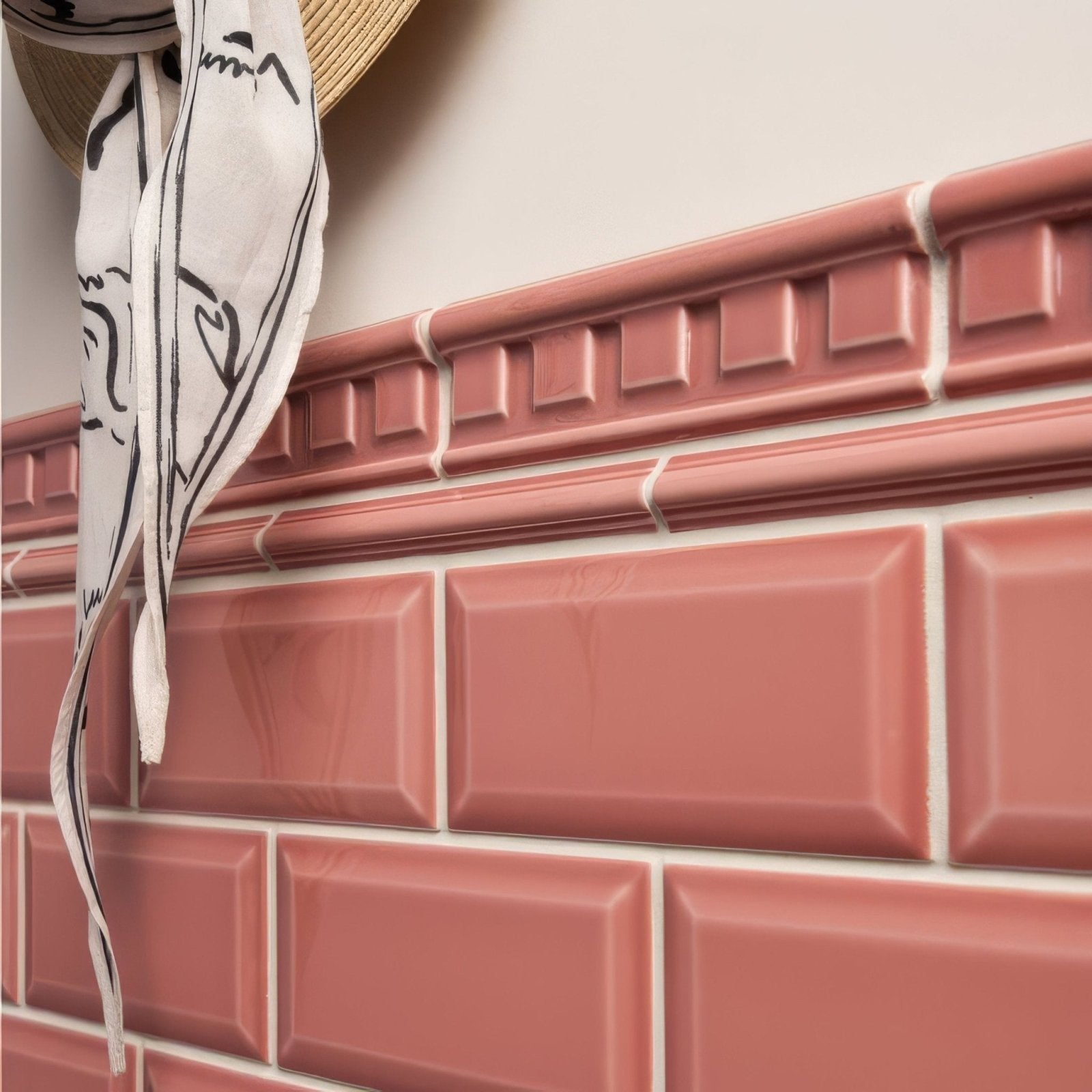 Pink ceramic duchy pink metro bevelled tile with glossy finish and raised edges arranged in classic brick pattern